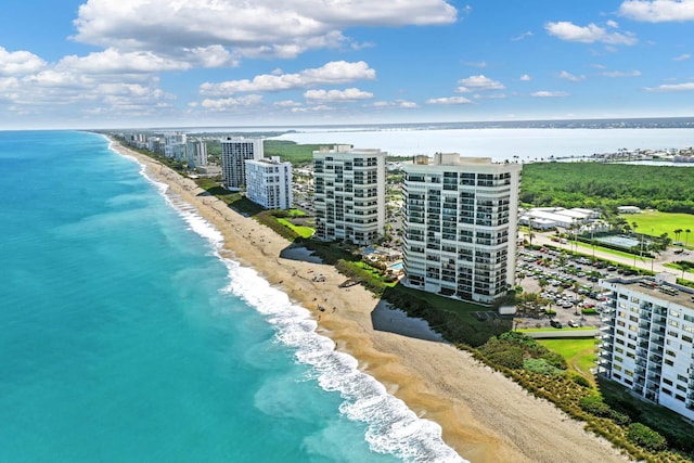 drone / aerial view featuring a water view and a view of the beach