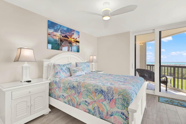 bedroom featuring hardwood / wood-style flooring, ceiling fan, floor to ceiling windows, and access to outside