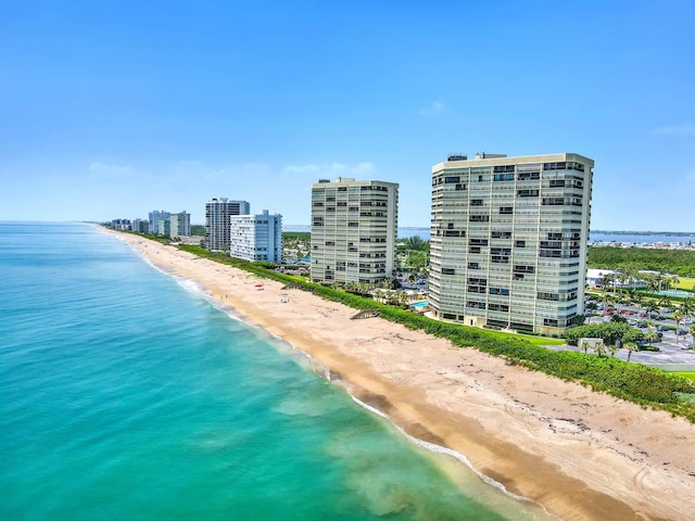 birds eye view of property featuring a water view and a beach view