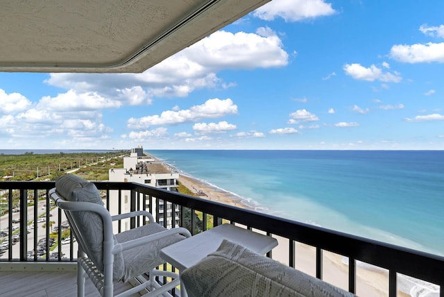 balcony featuring a water view and a view of the beach