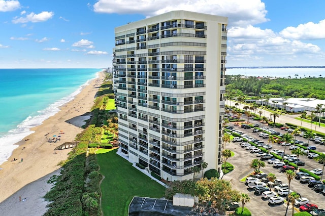 view of property with a view of the beach and a water view