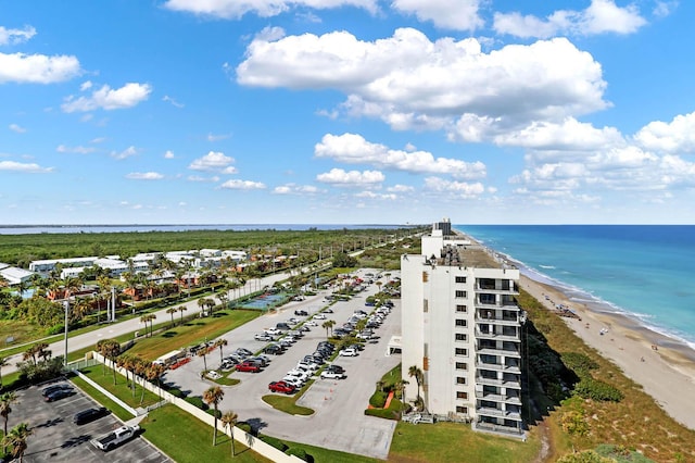 birds eye view of property with a water view and a beach view