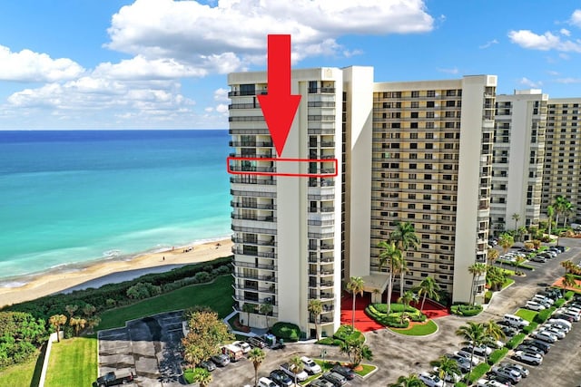 exterior space with a water view and a view of the beach