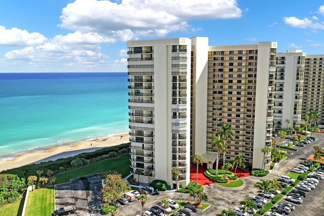 view of property featuring a beach view and a water view