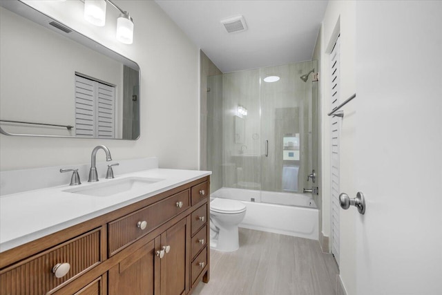 1714 Palmland Dr Unit 1714, Boynton Beach, FL 33436 - bathroom with toilet, vanity, combined bath / shower with glass door, and wood finished floors