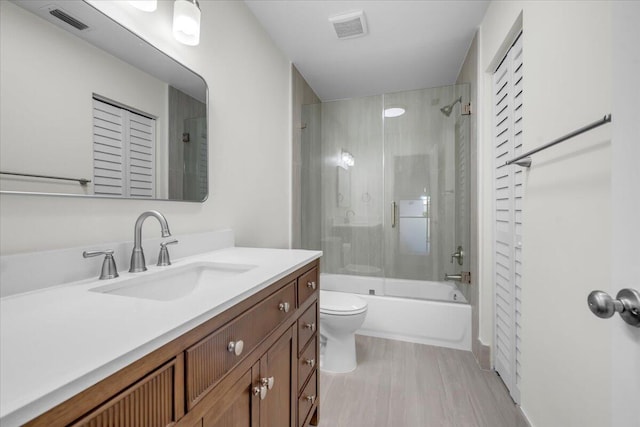 1714 Palmland Dr Unit 1714, Boynton Beach, FL 33436 - full bath with vanity, toilet, bath / shower combo with glass door, and wood finished floors