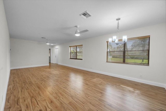1714 Palmland Dr Unit 1714, Boynton Beach, FL 33436 - unfurnished room featuring a chandelier, light wood-style flooring, a ceiling fan, and baseboards
