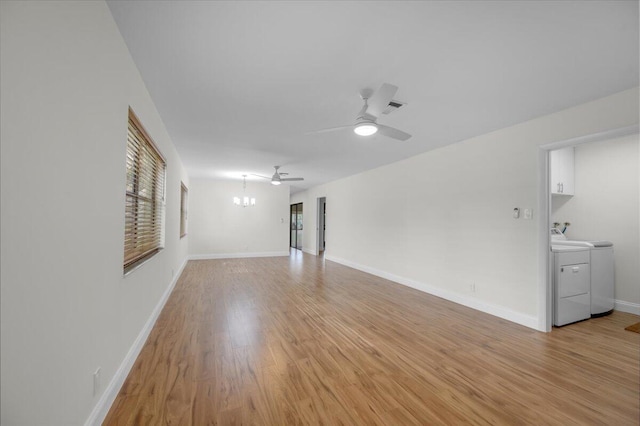 1714 Palmland Dr Unit 1714, Boynton Beach, FL 33436 - unfurnished room featuring washing machine and dryer, light wood-style floors, a ceiling fan, a chandelier, and baseboards