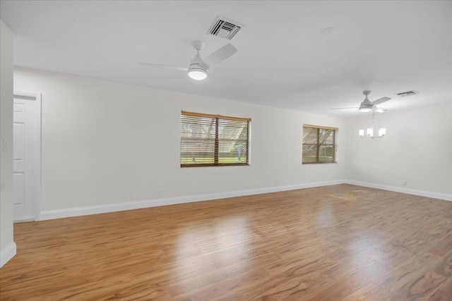 1714 Palmland Dr Unit 1714, Boynton Beach, FL 33436 - spare room featuring a ceiling fan, light wood-style flooring, baseboards, and a chandelier