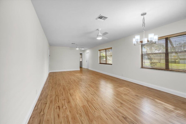 1714 Palmland Dr Unit 1714, Boynton Beach, FL 33436 - spare room with a chandelier, light wood-type flooring, baseboards, and a ceiling fan