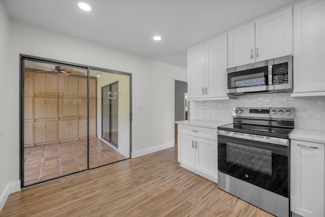 1714 Palmland Dr Unit 1714, Boynton Beach, FL 33436 - kitchen featuring stainless steel appliances, baseboards, light countertops, light wood-style floors, and recessed lighting