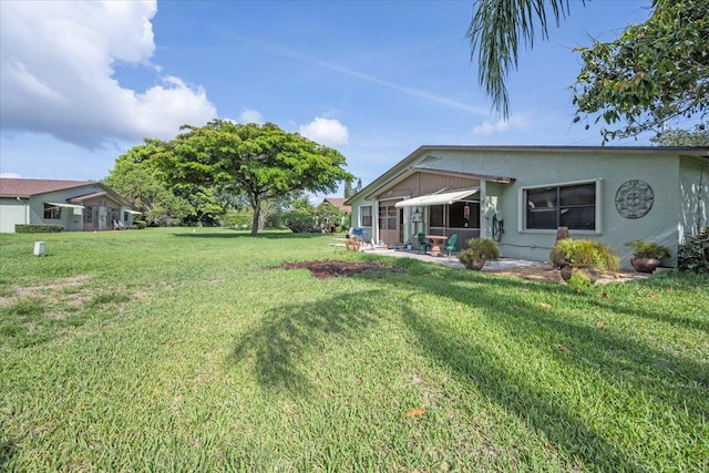 1714 Palmland Dr Unit 1714, Boynton Beach, FL 33436 - view of green lawn with a patio