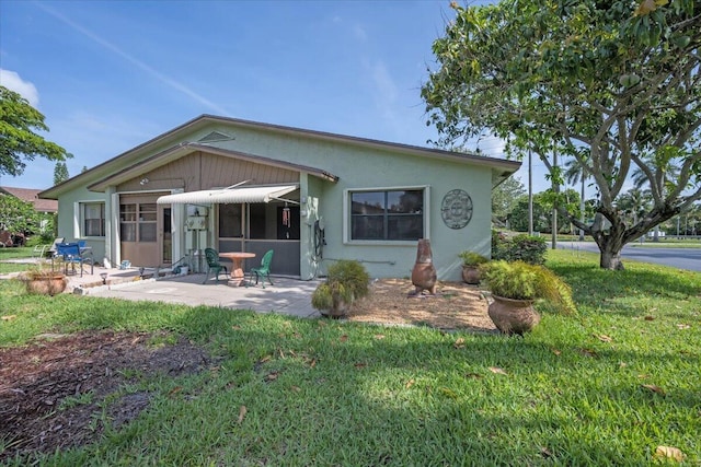 1714 Palmland Dr Unit 1714, Boynton Beach, FL 33436 - view of front of home featuring a patio area, a front lawn, and stucco siding