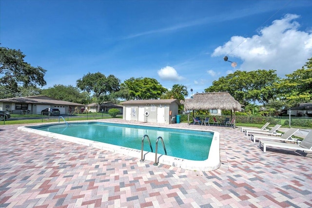 1714 Palmland Dr Unit 1714, Boynton Beach, FL 33436 - community pool featuring a patio and an outdoor structure