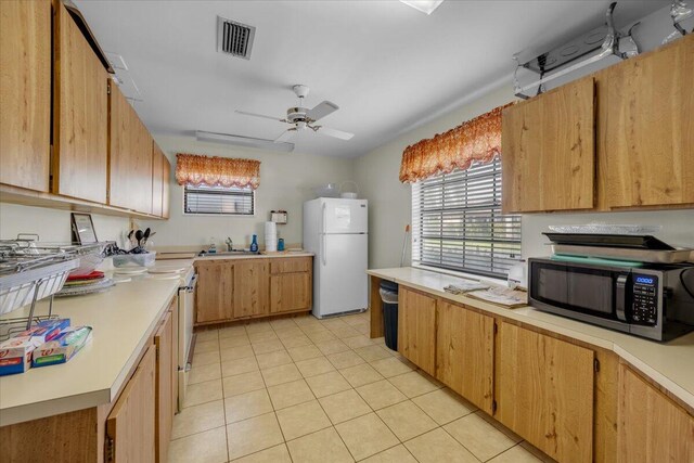 1714 Palmland Dr Unit 1714, Boynton Beach, FL 33436 - kitchen featuring white appliances, light countertops, light tile patterned floors, a sink, and a ceiling fan