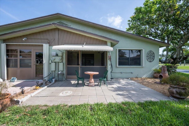 1714 Palmland Dr Unit 1714, Boynton Beach, FL 33436 - back of property featuring a patio area and stucco siding