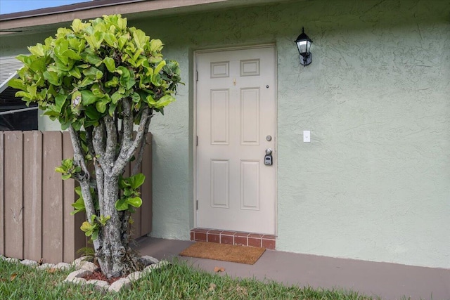 1714 Palmland Dr Unit 1714, Boynton Beach, FL 33436 - view of exterior entry featuring stucco siding