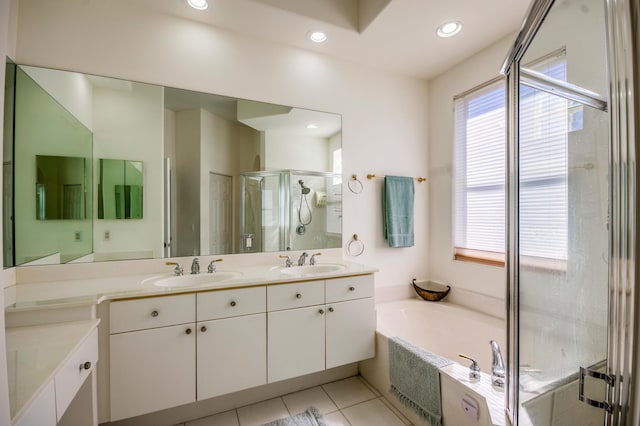 bathroom with shower with separate bathtub, vanity, and tile patterned floors