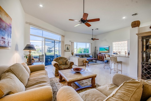 living room featuring light hardwood / wood-style floors and ceiling fan