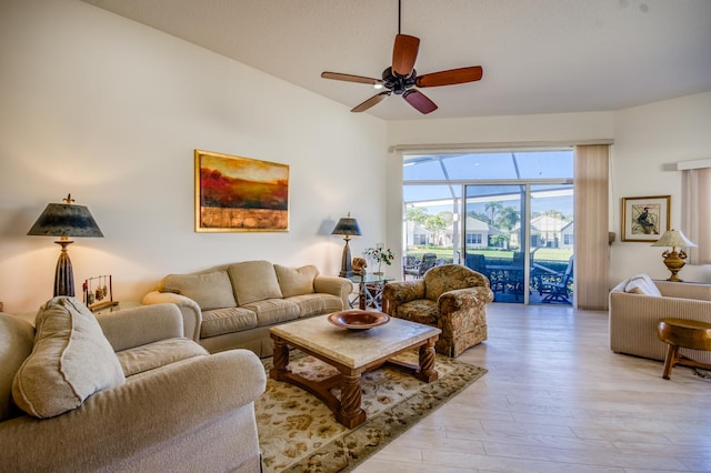 living room with light hardwood / wood-style floors and ceiling fan