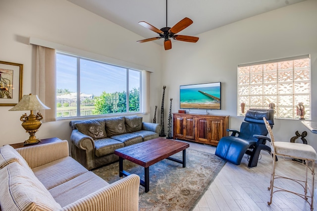 living room with ceiling fan and light wood-type flooring