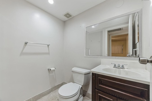 bathroom featuring toilet, baseboards, visible vents, and vanity