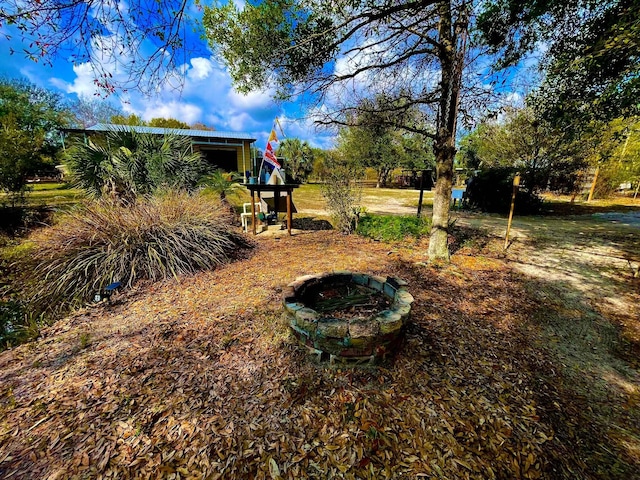 view of yard featuring an outdoor fire pit