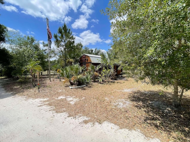 16738 NW 262nd St, Okeechobee, FL 34972 - view of yard featuring a shed and an outbuilding