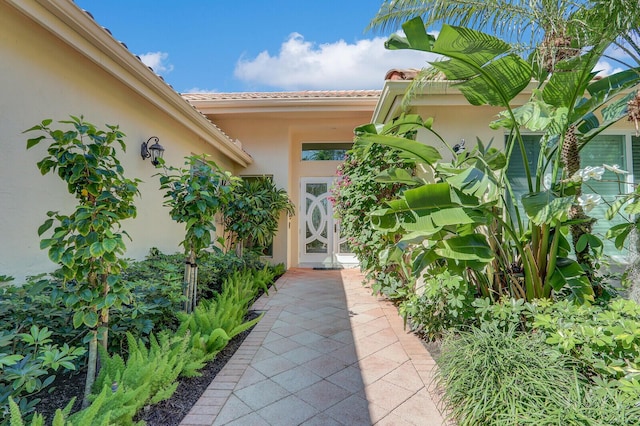 property entrance with stucco siding