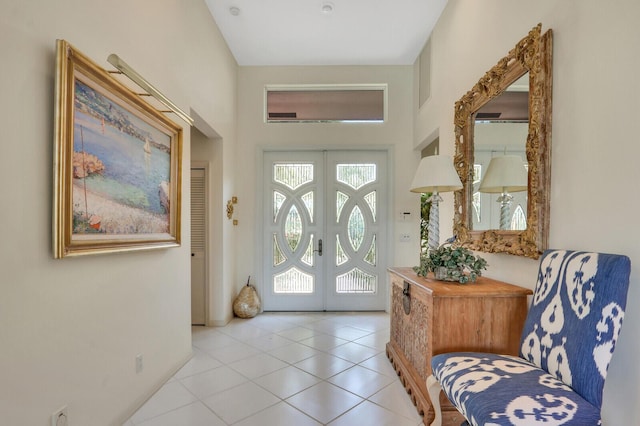 entrance foyer with light tile patterned floors and french doors