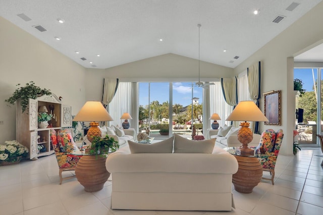 living room with lofted ceiling, visible vents, ceiling fan, and light tile patterned floors