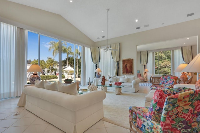 living area featuring lofted ceiling, light tile patterned floors, visible vents, and recessed lighting