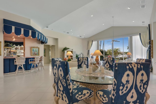 dining area with lofted ceiling, ceiling fan, light tile patterned floors, and visible vents