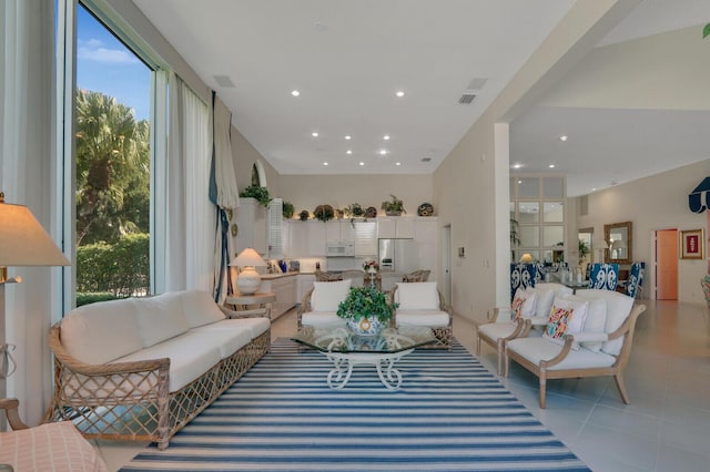 living area with recessed lighting and light tile patterned floors