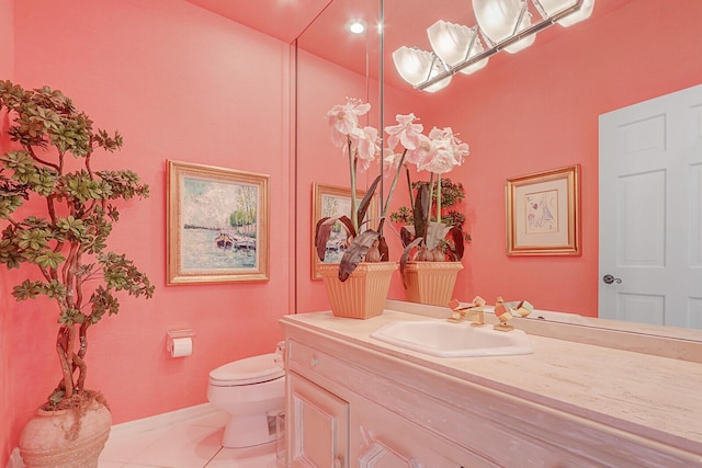 half bath featuring vanity, toilet, and tile patterned floors