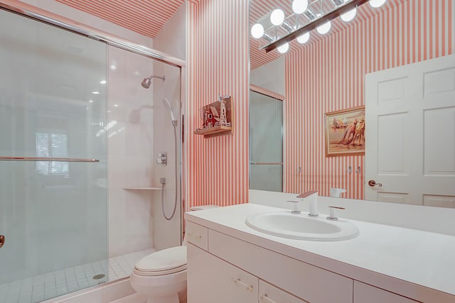 bathroom featuring toilet, a stall shower, and wallpapered walls