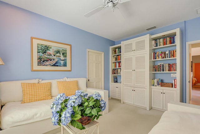 sitting room with light carpet, ceiling fan, and visible vents