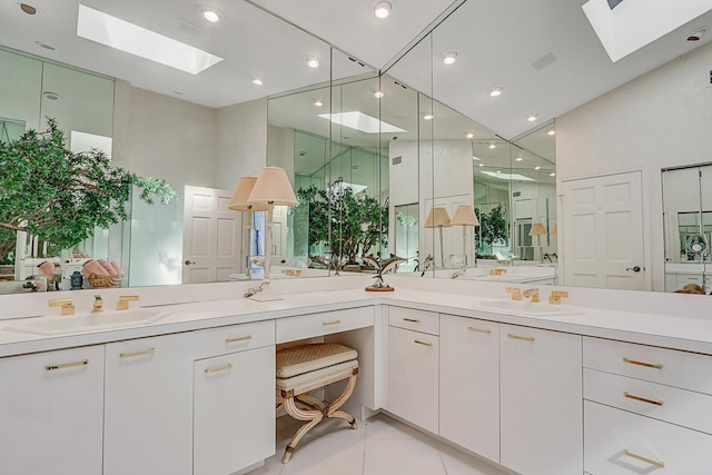 full bathroom featuring recessed lighting, a skylight, vanity, and tile patterned floors