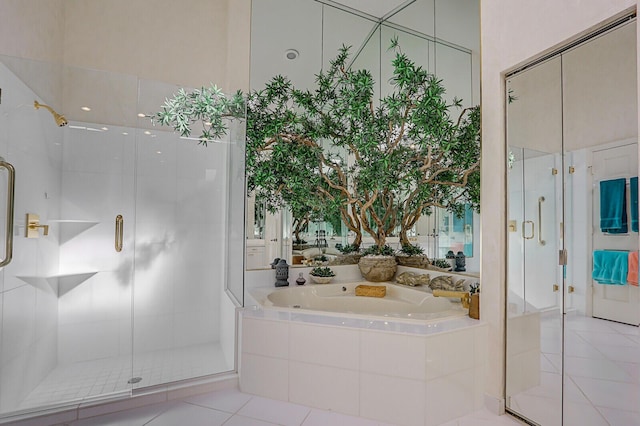 full bath featuring a stall shower, tile patterned floors, and a bath