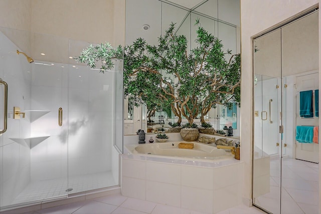 full bath with a garden tub, a shower stall, and tile patterned floors