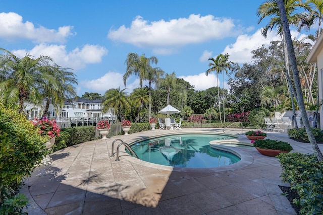 outdoor pool with a patio area