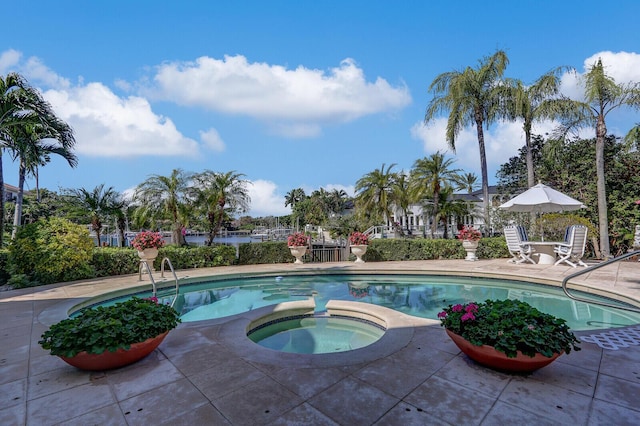 view of swimming pool featuring a patio area and a pool with connected hot tub