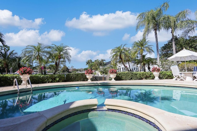 view of swimming pool featuring a pool with connected hot tub