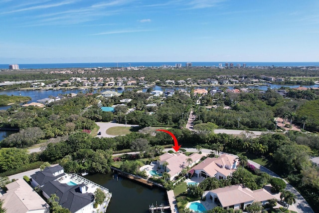 drone / aerial view featuring a water view and a residential view