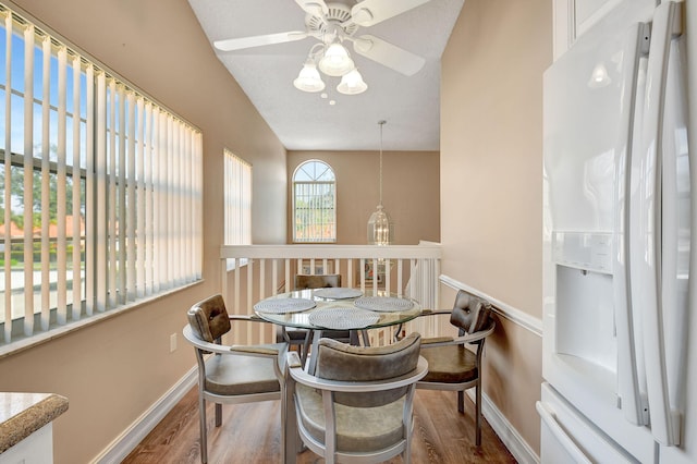 dining area with ceiling fan, baseboards, and wood finished floors