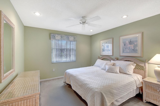 carpeted bedroom featuring a textured ceiling and ceiling fan