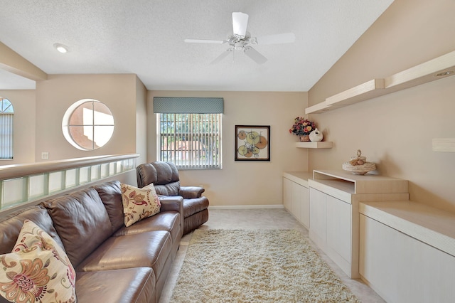 living area with baseboards, lofted ceiling, light carpet, a textured ceiling, and a ceiling fan