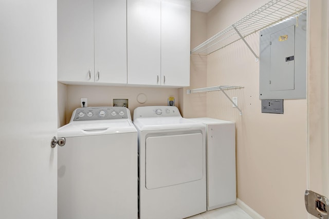 clothes washing area with electric panel, cabinet space, baseboards, and separate washer and dryer