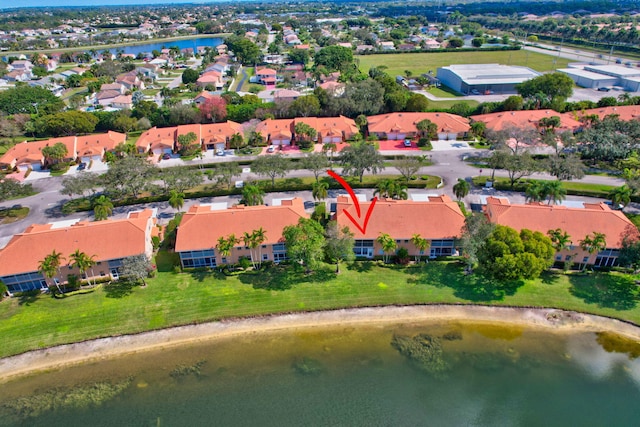 drone / aerial view with a residential view and a water view