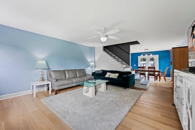 living room with ceiling fan and light hardwood / wood-style floors